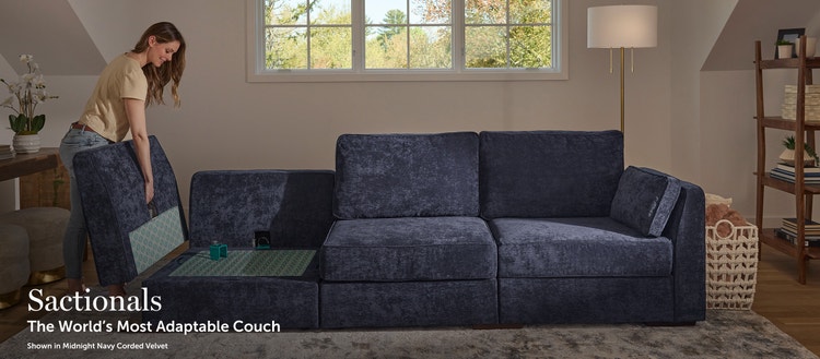 Woman rearranging her blue Lovesac sectional couch