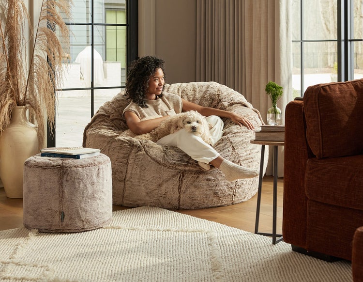 Woman relaxing on a Lovesac MovieSac bean bag chair