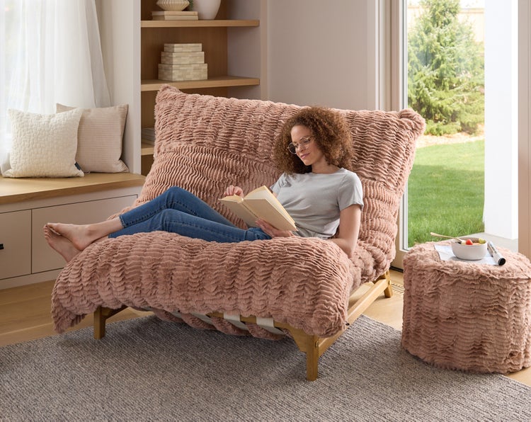 Woman sitting on a Lovesac PillowSac bean bag chair