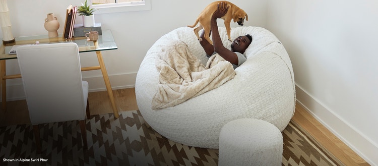 Man sitting on a Lovesac Bean Bag Chair